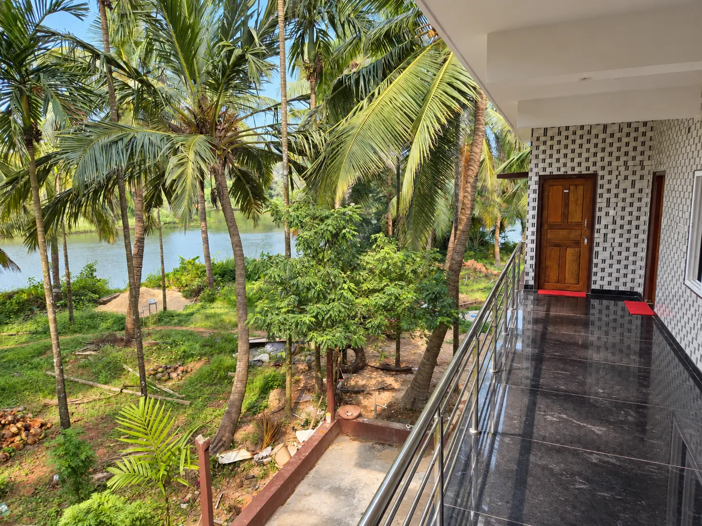 Upper-level balcony looking over the palms toward the river