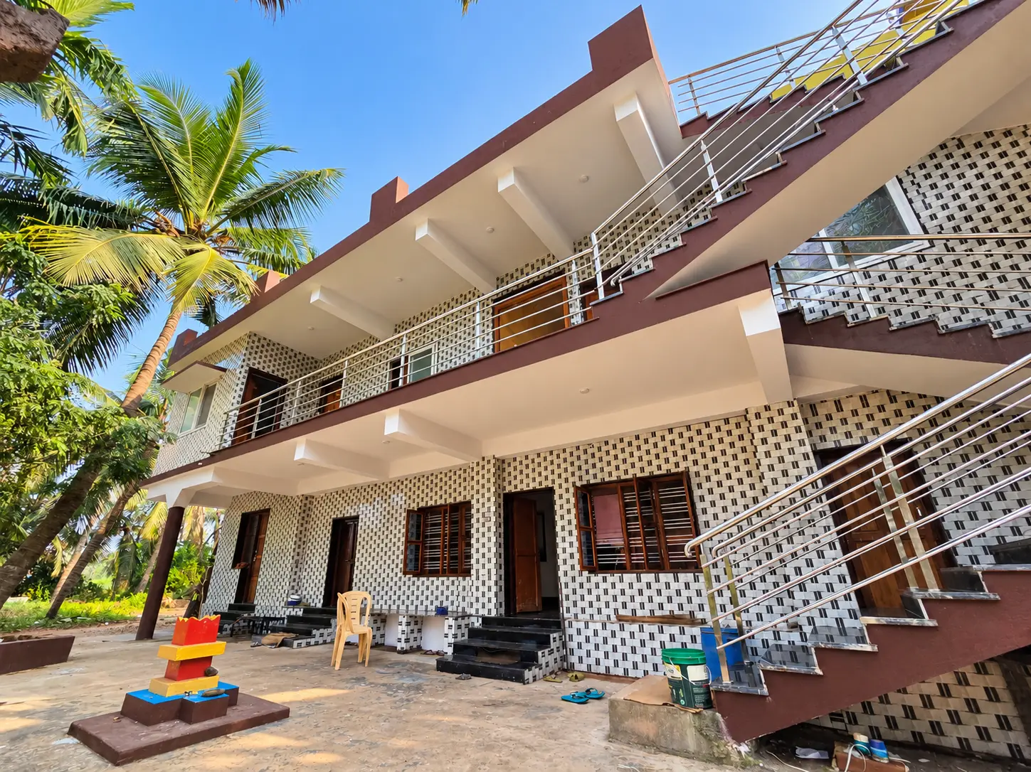 Two-storey guest building with an outdoor staircase and courtyard